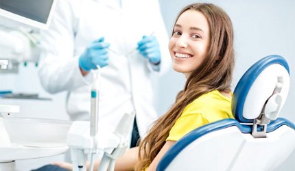 Happy dental patient looking over her shoulder
