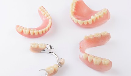full and partial dentures sitting on a countertop