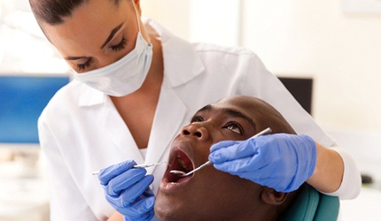 Dentist in DeSoto performing a dental exam on patient