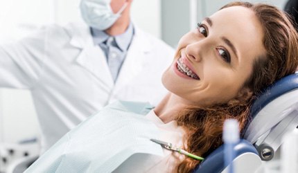 A woman wearing braces while receiving dental care