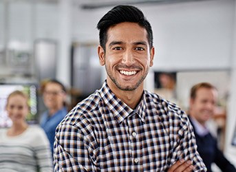 Smiling man wearing black and white plaid shirt
