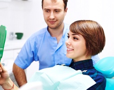 Woman looking in dental mirror