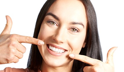 Woman pointing to her smile