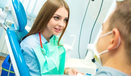 A female patient talking with her dentist