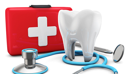 Model of a tooth next to a first-aid kit