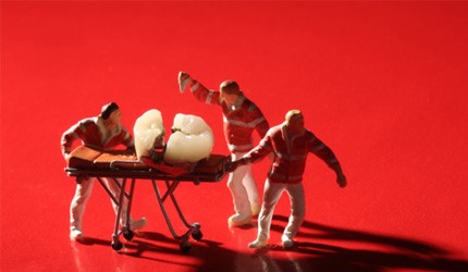 Miniature workers performing dental procedures