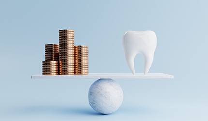 A scale weighing coins and a giant model tooth