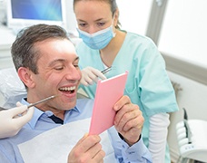 A dentist explaining the cost of tooth extraction in DeSoto