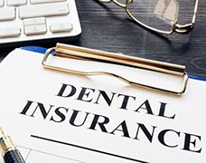 dental insurance form on a blue clipboard 