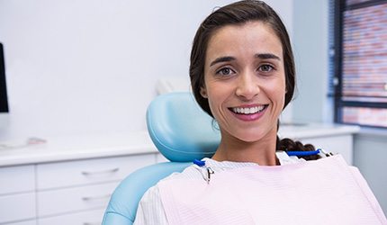 Female patient sitting in chair smiling
