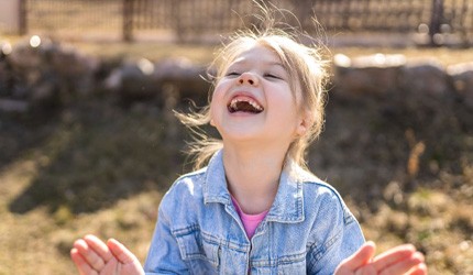 young girl smiling outside 