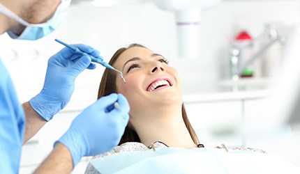 Woman smiling before getting full mouth reconstruction in DeSoto