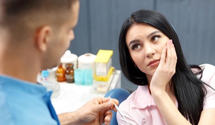 woman with toothache about to receive root canal therapy in DeSoto