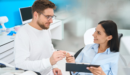 Woman talking with patient coordinator about cost 