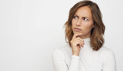 Woman holding her chin and thinking about root canal therapy