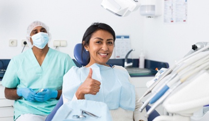 Woman giving thumbs up after getting tooth-colored fillings in DeSoto