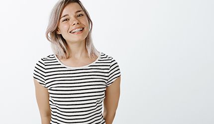 a woman in DeSoto smiling with metal braces