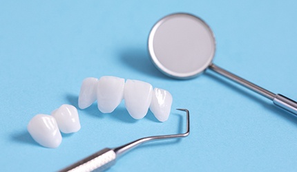 Veneers lying on table with dental tools