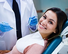 Woman smiling in cosmetic dentist's treatment chair