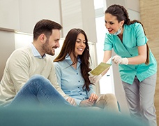 Dentist reviewing paperwork with patients