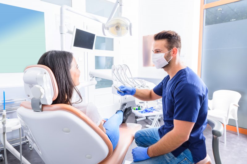 patient talking to dentist about health factors