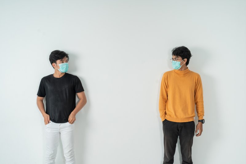 two people with masks social distancing