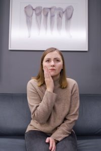 Woman with a tooth infection at emergency dentist