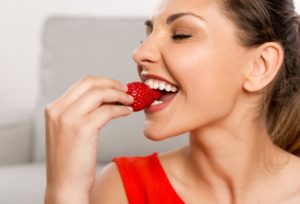 woman eating strawberries