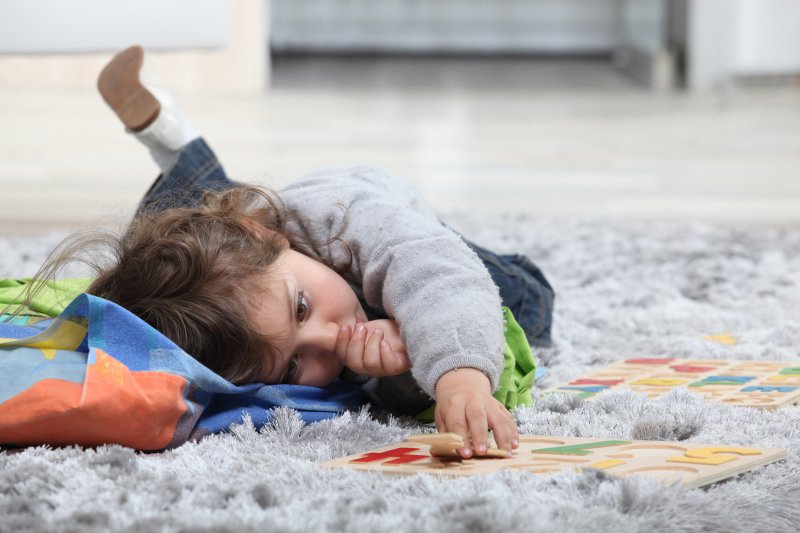 A toddler sucking their thumb 