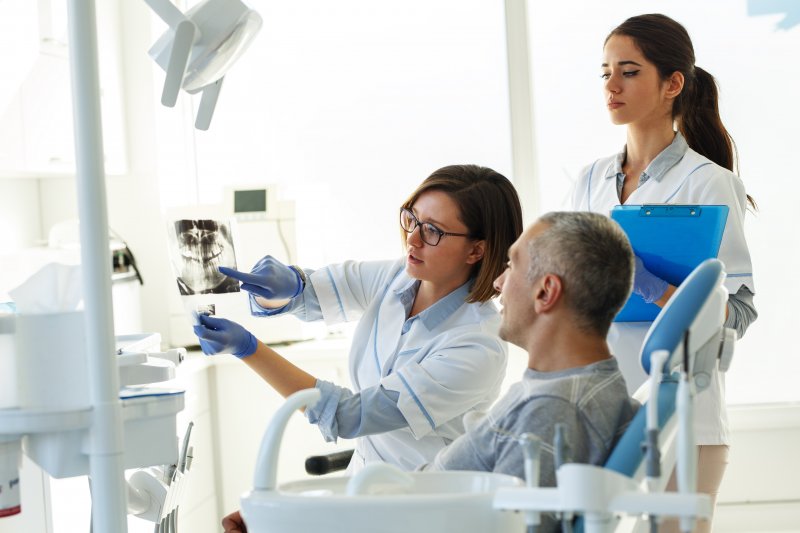 Patient talking to their dentist about dental emergencies
