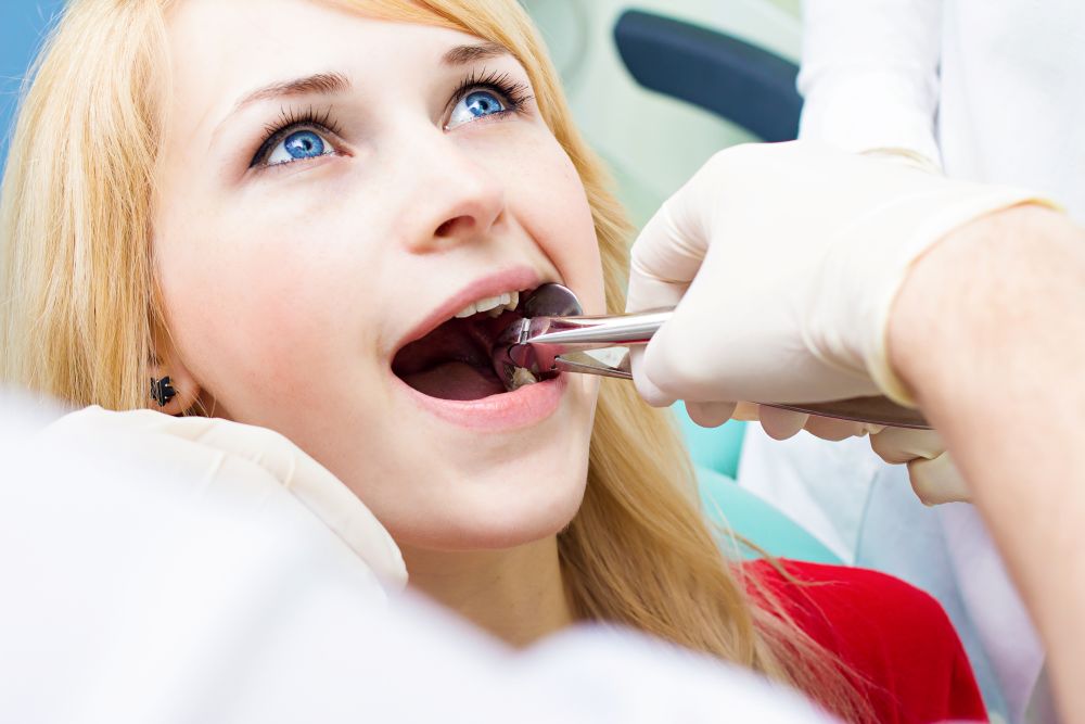 A woman getting her tooth extracted