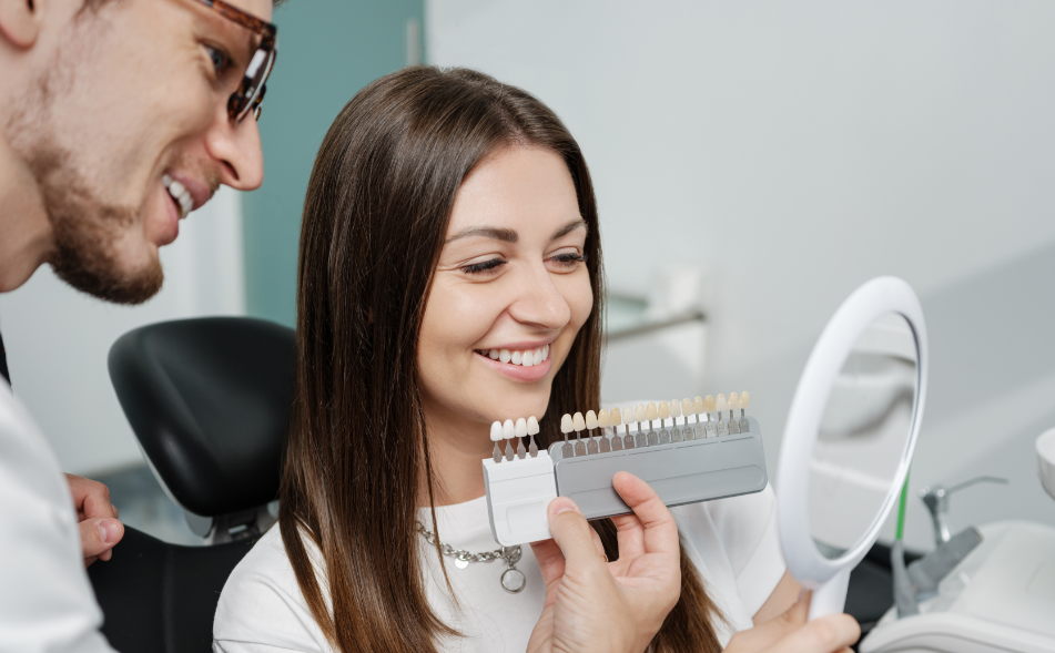 Dentist showing patient veneers