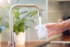 Person filling cup with water